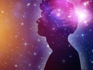 Side view of a person with a backdrop of the galaxy.