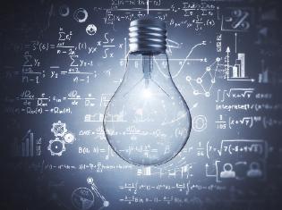 A lightbulb in the foreground with mathematical equations written in the background.