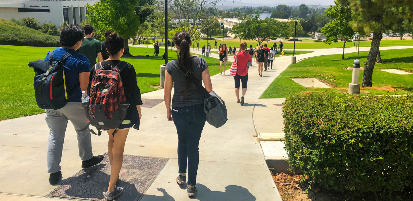 Students walk along a pathway on the Moorpark College campus