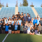 Moorpark College men’s and women’s track and field and cross country student-athletes pose with championship trophies on a stadium field