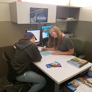 Courtney conducting in-person appointment with student