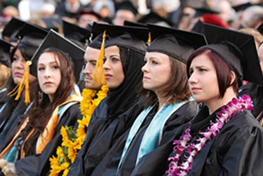 photo of a row of students listening to the graduation speak