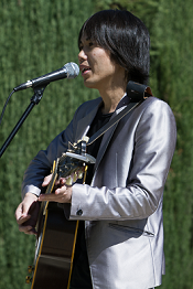 A singer plays the guitar at the 2013 Multicultural Day even