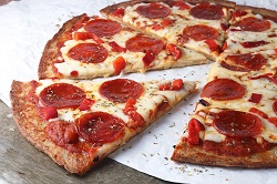 pizza.jpg Pepperoni pizza on a white tablecloth.