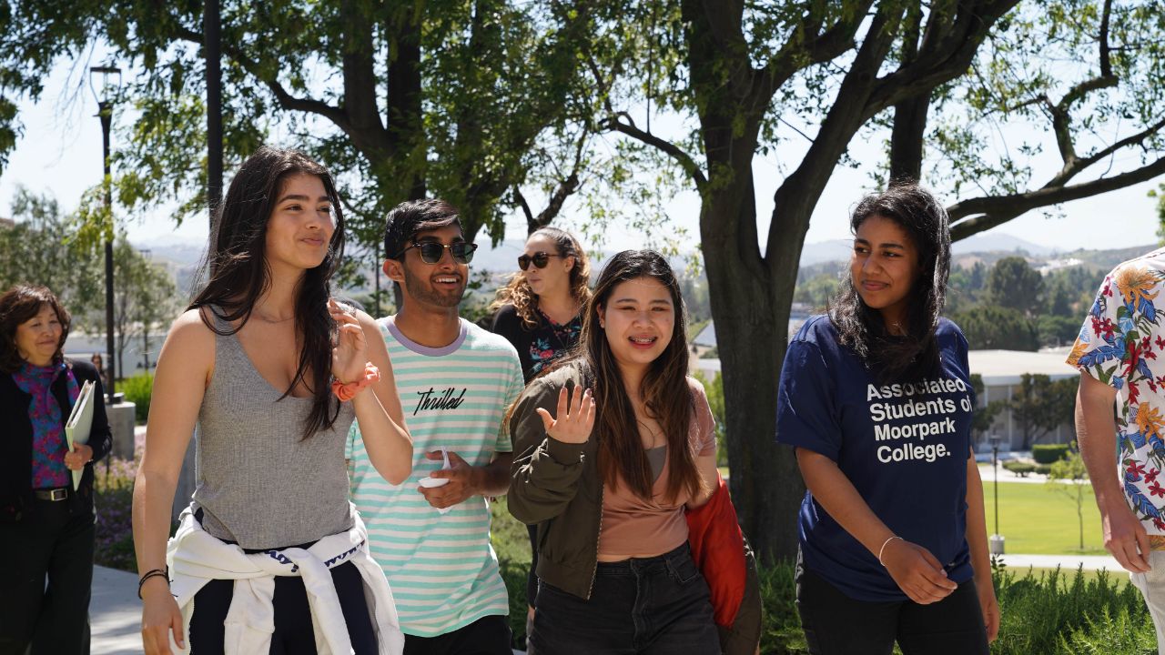 A group of diverse looking students walk to class.