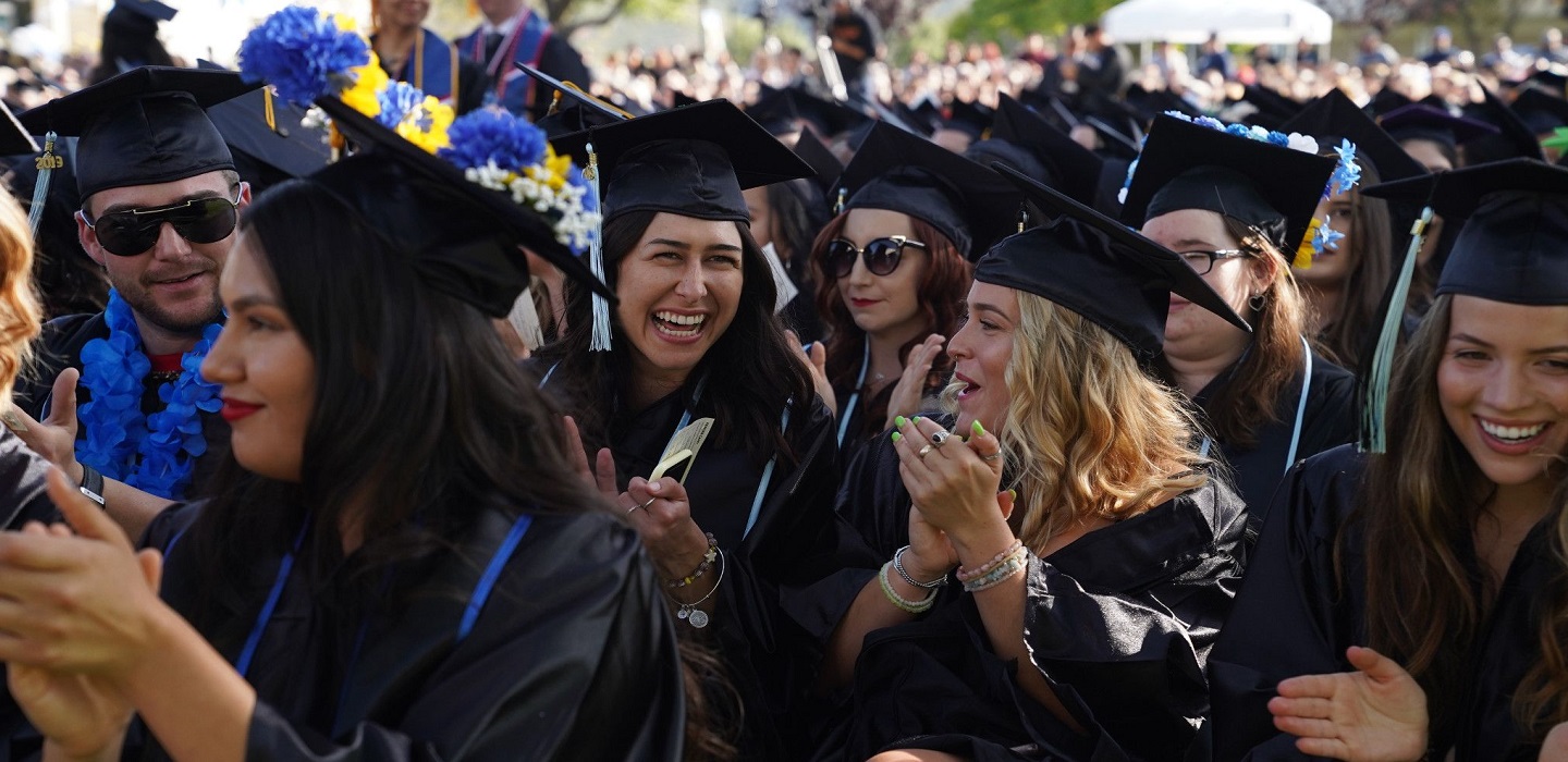 Students applaud fellow graduates during Commencement.