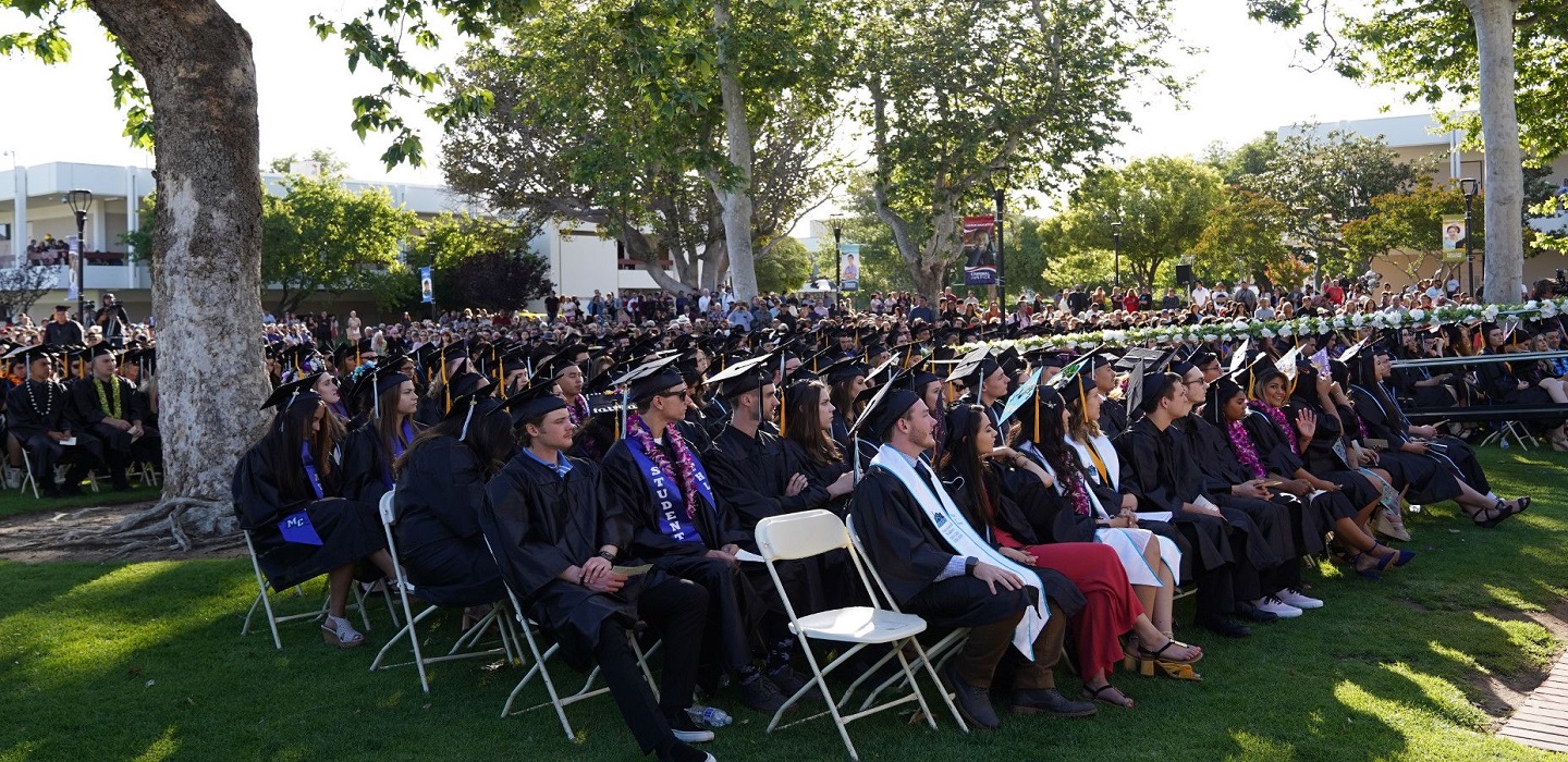 Graduating students sit as they listen to commencement addresses.