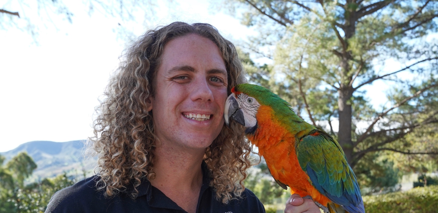 student holding a parrot