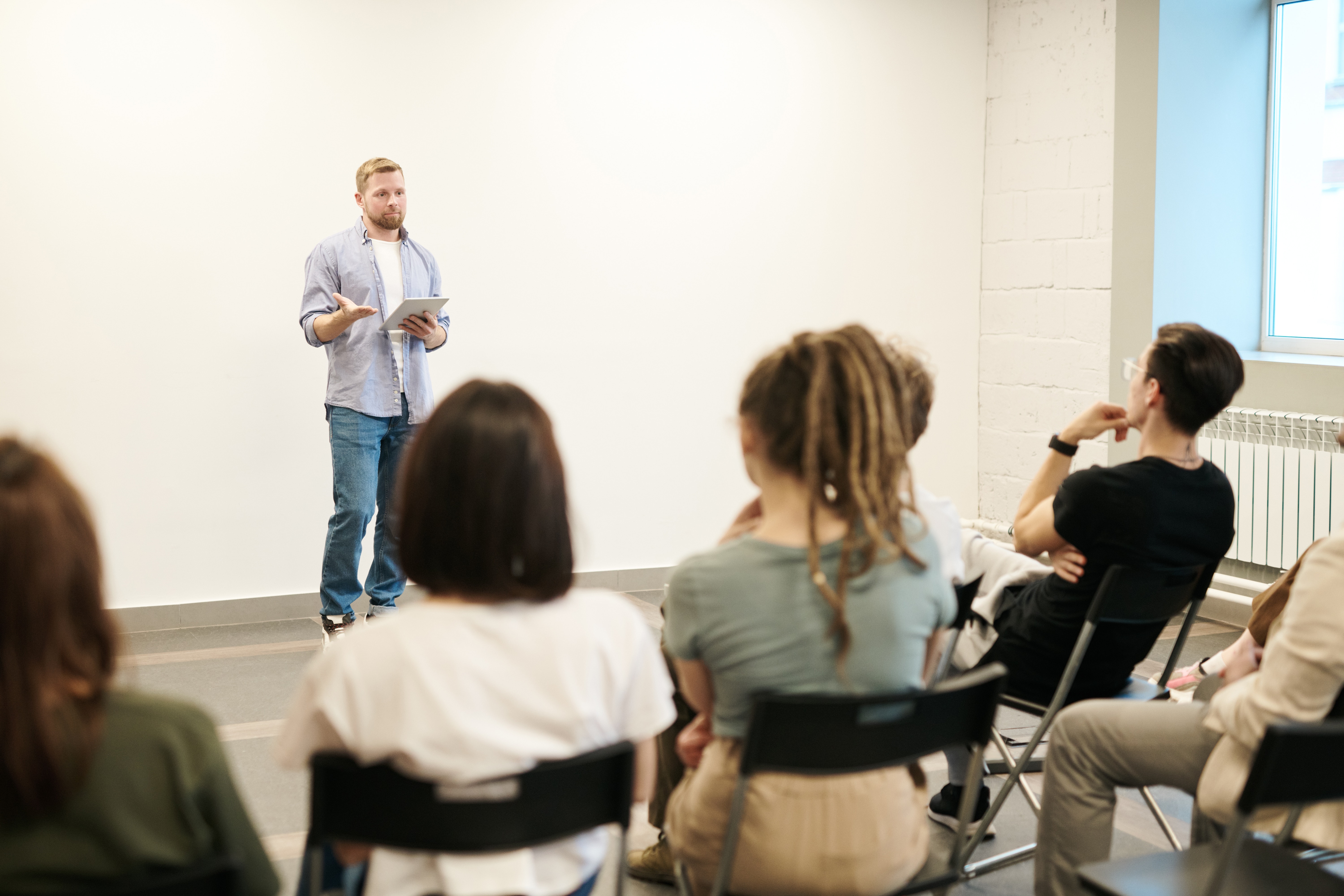 Professor giving lecture in a classroom to a group of students