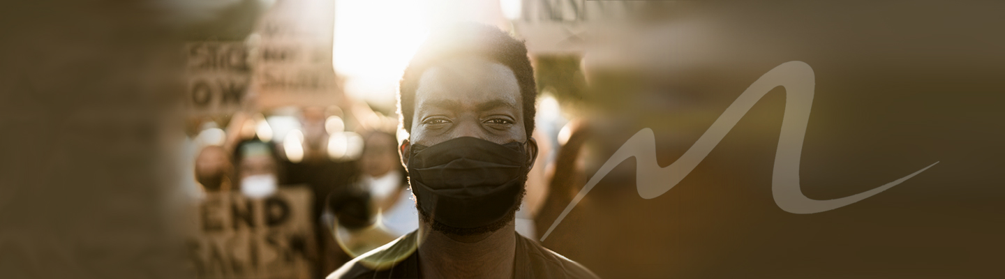 Black man with black mask at social justice march