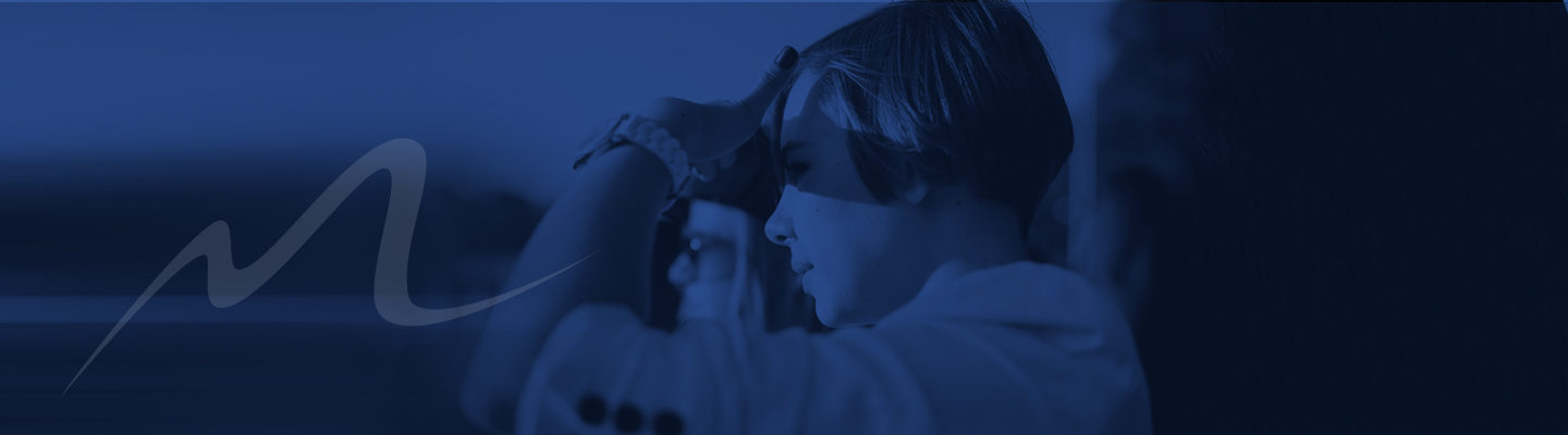 Young woman looks toward the horizon in a sea of blue