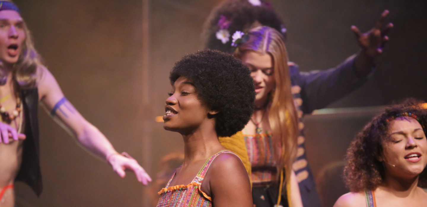 Students sing during a performance of "Hairspray".