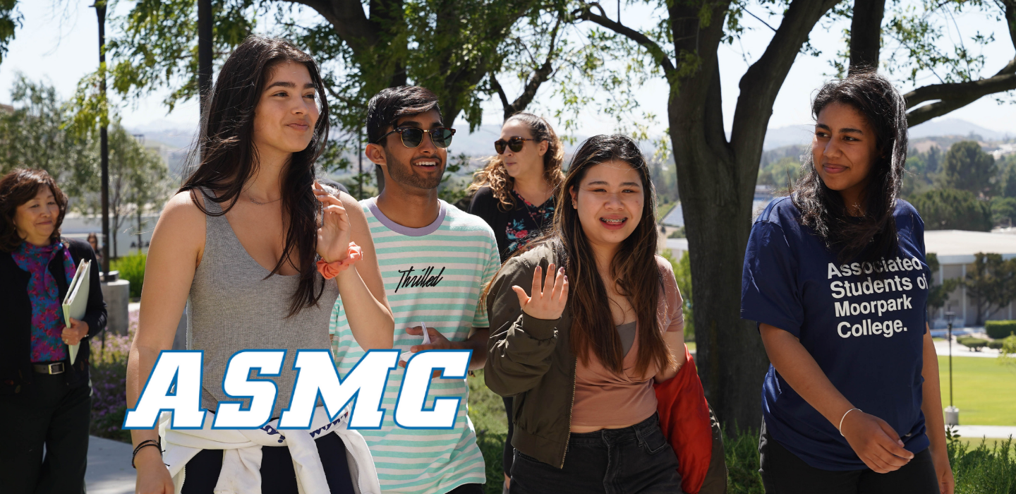 Students walk through campus smiling during the daytime