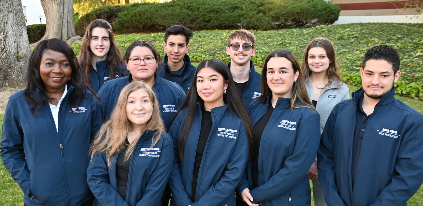 Members of the 2021-2022 Associated Students pose for a group picture standing up.