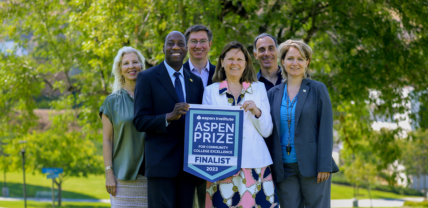 moorpark college exec team holds aspen finalist banner outside