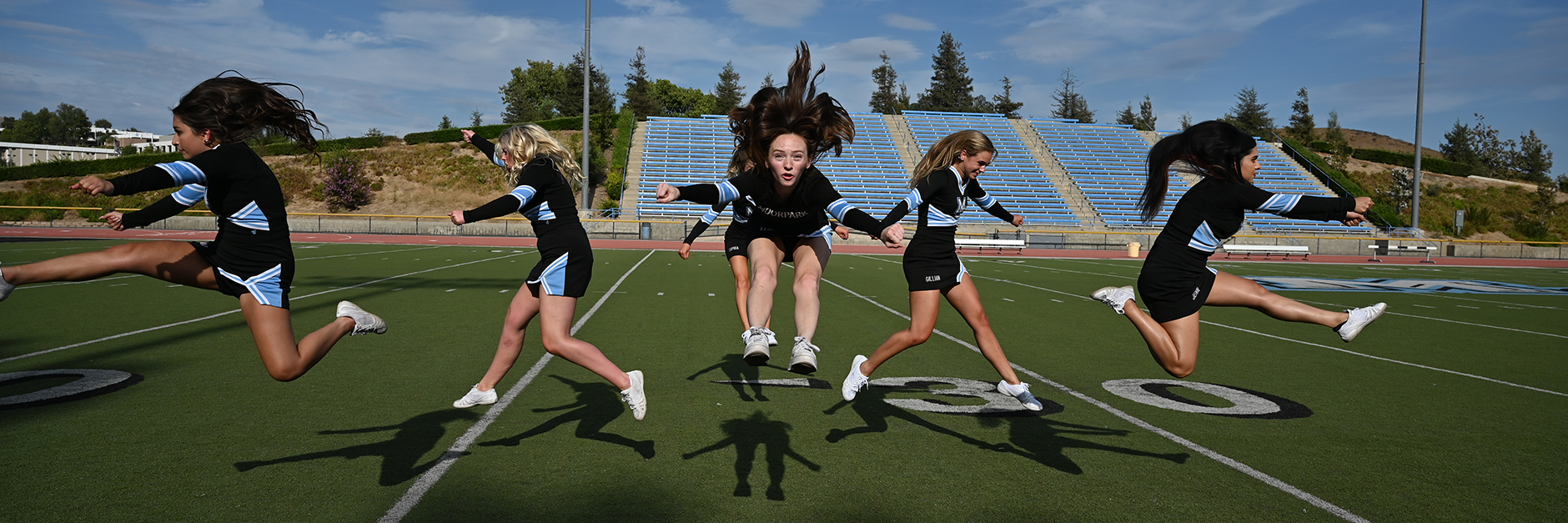 mc cheerleaders jumping in the air at the stadium