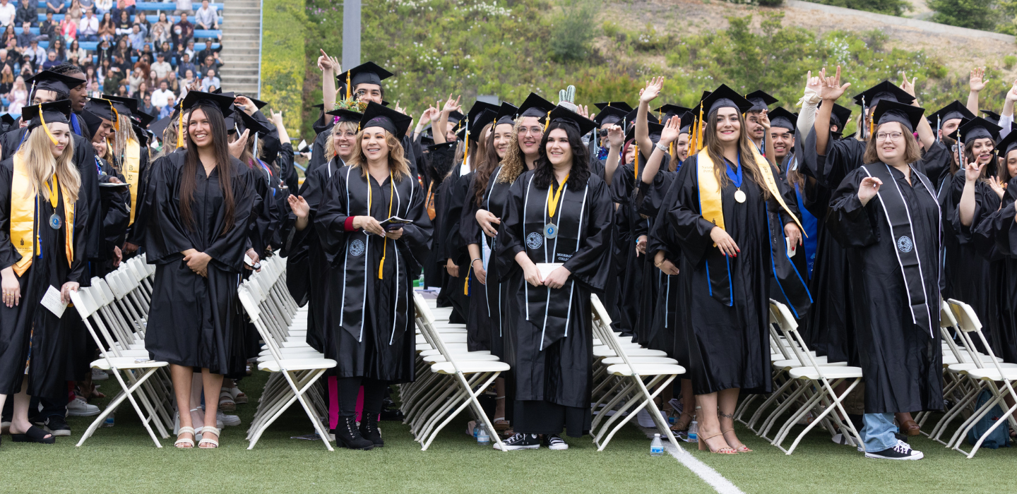Graduates wave to their loved ones during the May 2023 Commencement ceremony.