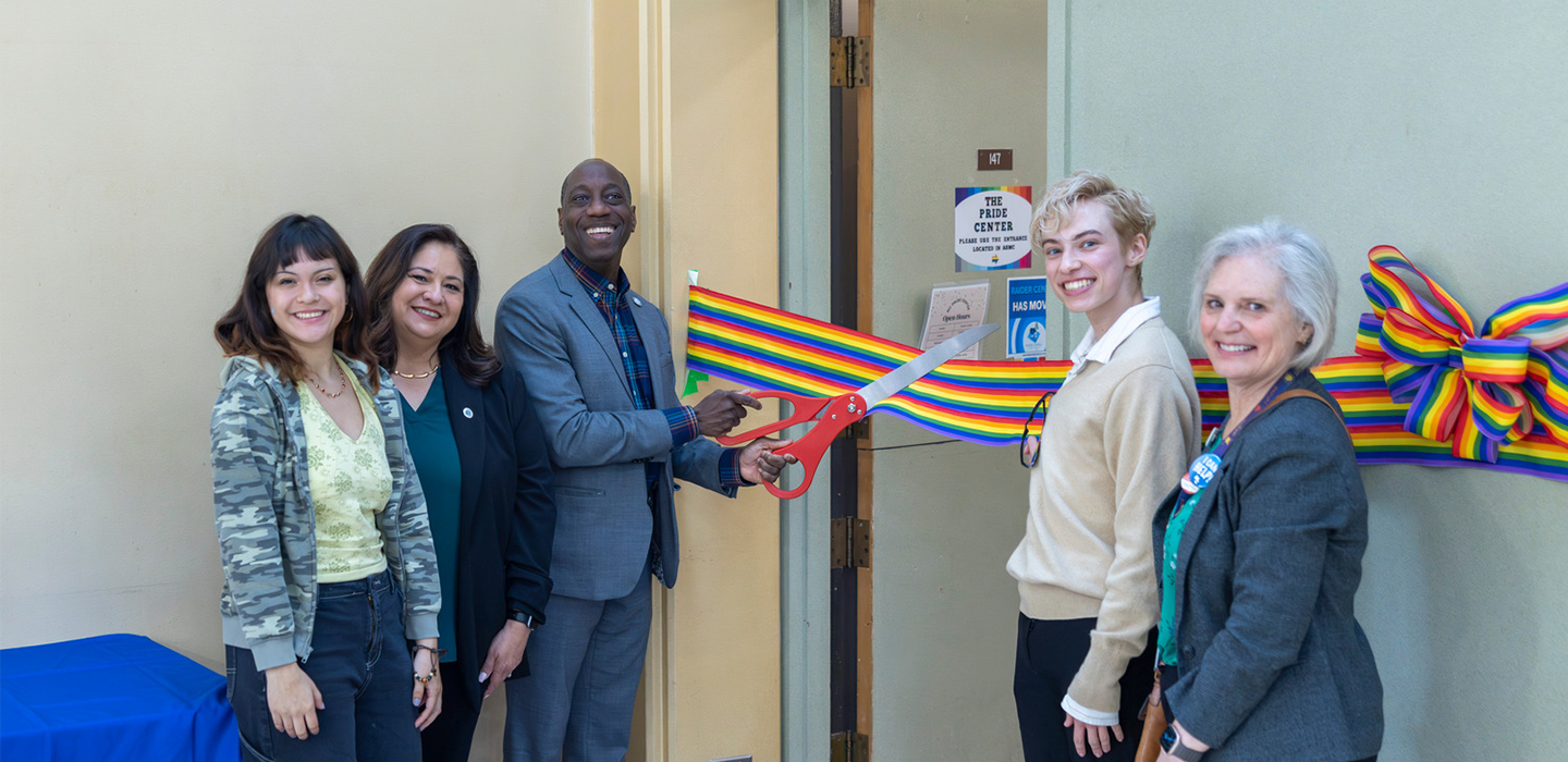 Students and faculty pictured cutting the ribbon at the Pride Center Grand Opening