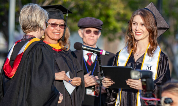 Student being awarded diploma at graduation