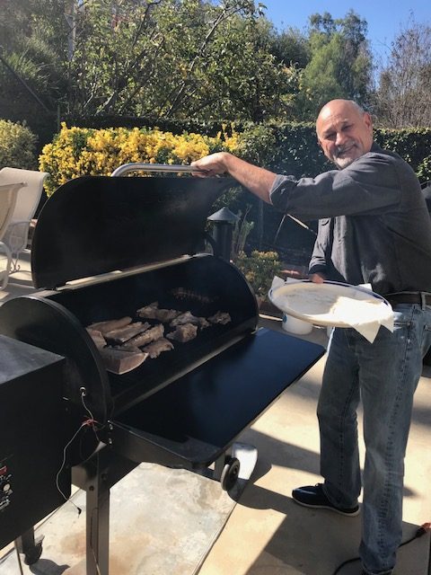 Vance barbecuing outside.