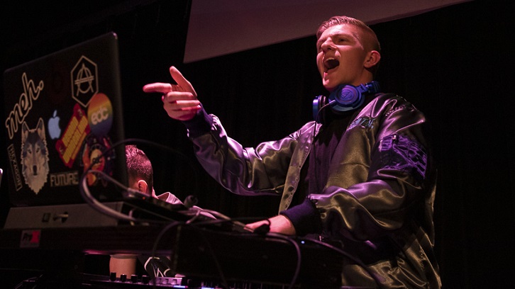 A student DJ spins tunes at an event.