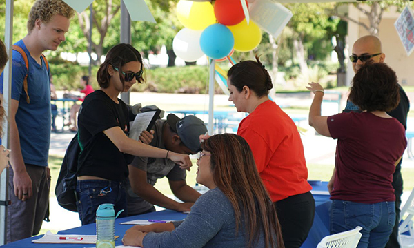 A group of students at a booth during a school event.