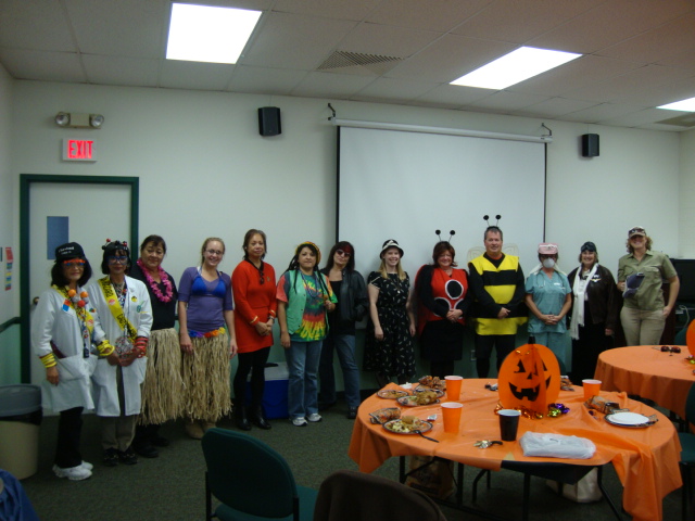 Staff dressed in costume for Halloween potluck