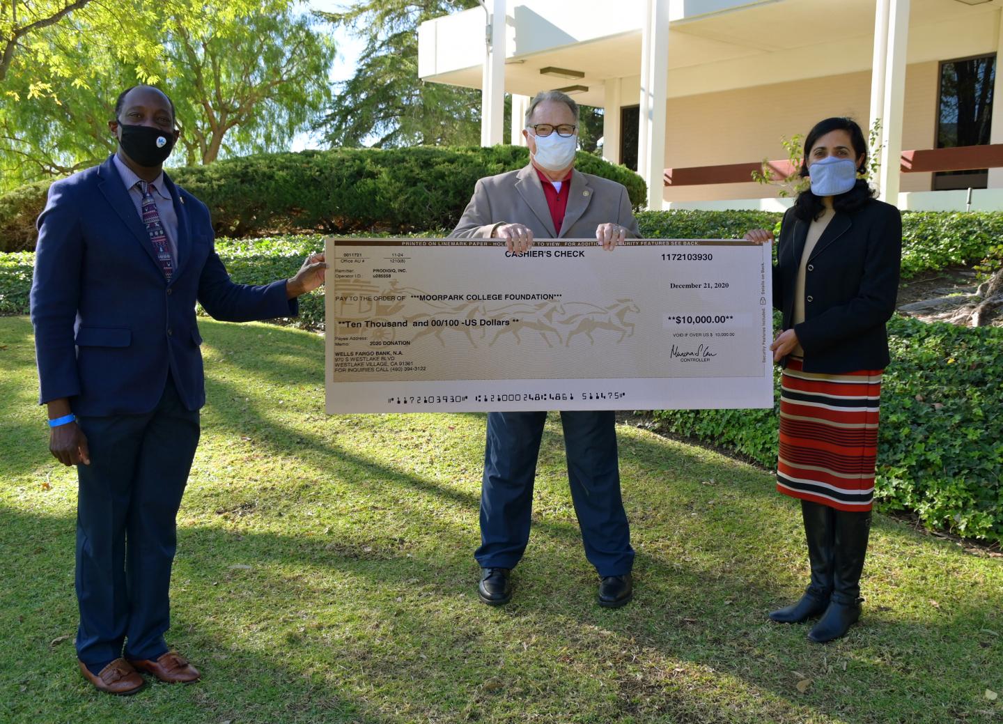 Julius Sokenu, Moorpark College Interim President, left, and Timothy Weaver, Moorpark College Foundation Vice President, accept a $10,000 check from Anita Venkataraman, President and CTO at ProDIGIQ, on behalf of the Moorpark College Foundation on Dec. 21.