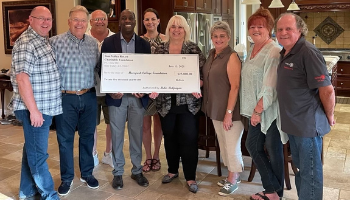 Members of the Simi Valley Rotary Charitable Foundation present a check to Julius Sokenu, president of Moorpark College and Jill Haney, chair of the Moorpark College Foundation. Pictured from left Allan Mann, John Lindsey, Hal Ward, Sokenu, Kelly Gaines, Haney, Sharon Austel, May Culbertson and Mike McGuigan.