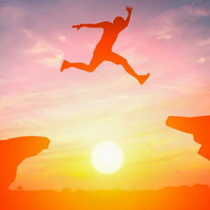 individual jumping cliff at sunset