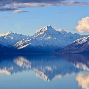 Snowy mountains with lake and a mountain reflection in the lake