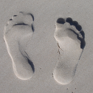 imprint of feet in sand
