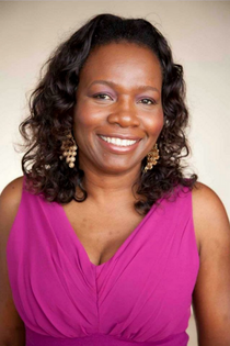 ASMC President Mary Poitier is shown smiling for the camera.