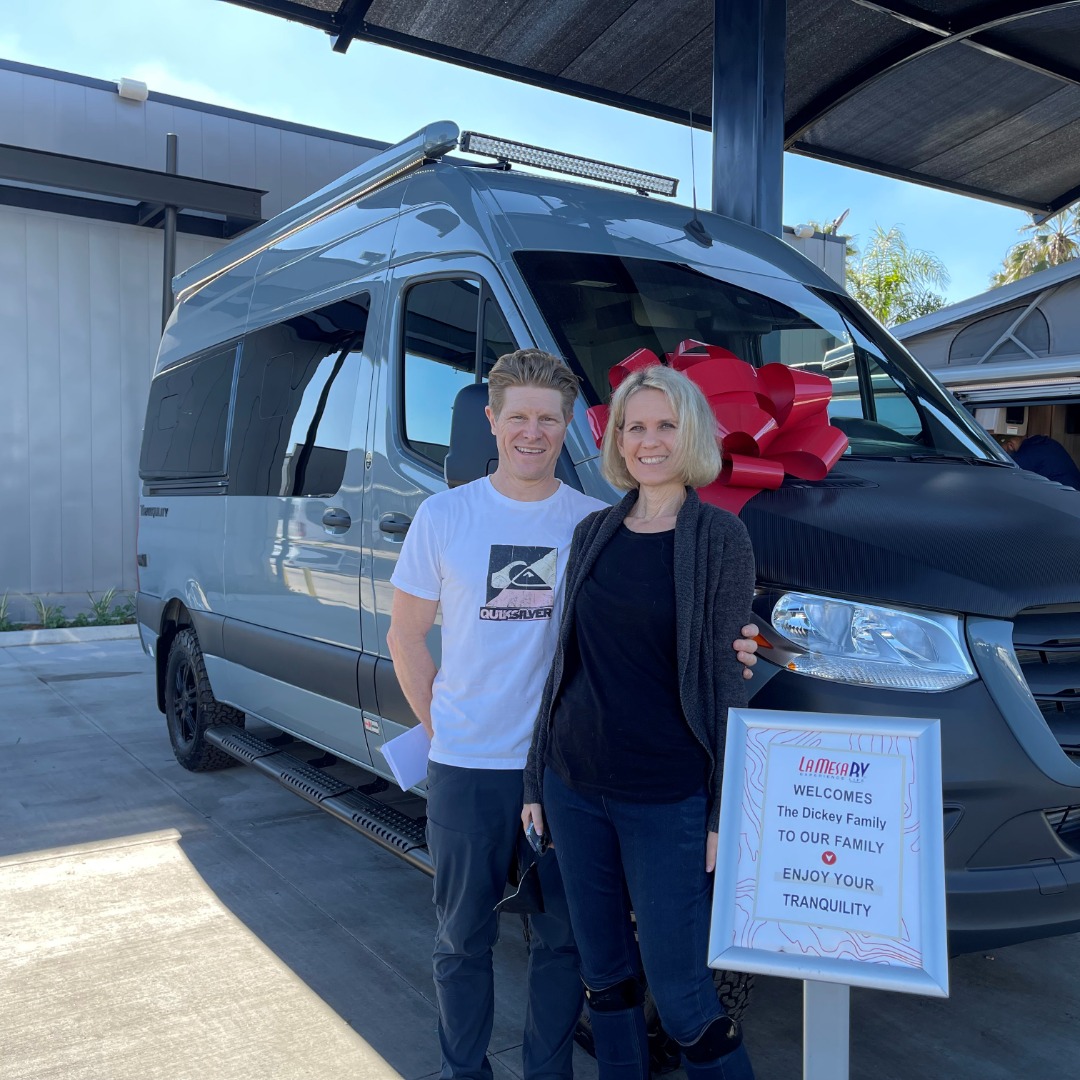 Image of Jodi Dickey and her husband with their new campervan