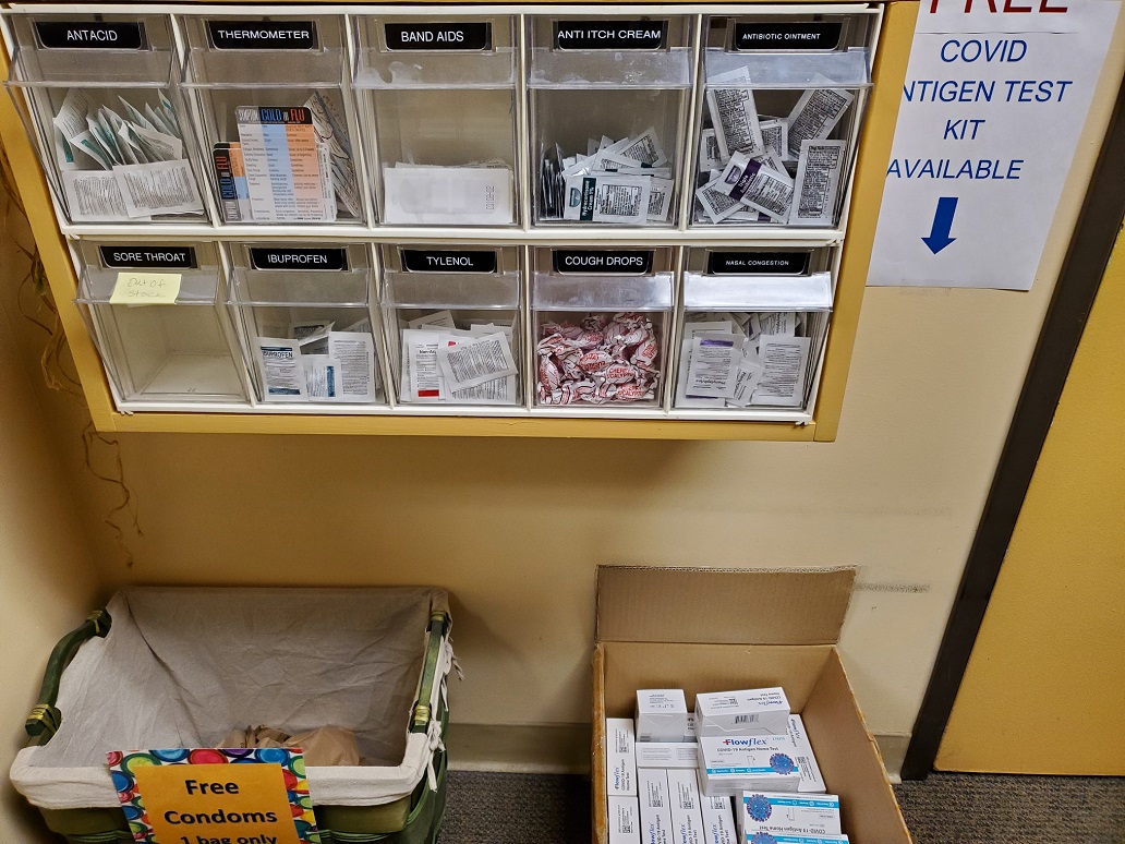 student health center self-help section with over the counter meds, COVID tests, and condoms