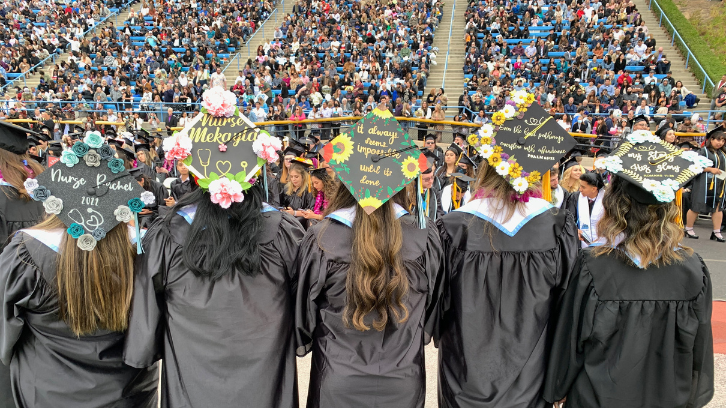 Nursing Science graduates show off their custom graduation caps.