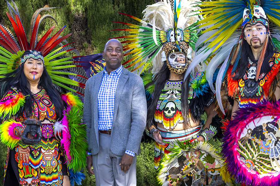 Dr Sokenu with colorful Aztec dancers