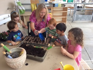children gardening with teacher
