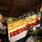 A young adult shopping for produce.
