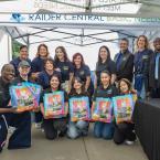 President Julius Sokenu, Raider Central Basic Needs staff, and VCCU representatives pose with donation bags of basic needs supplies for students. 