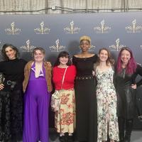 Professor Risdana standing proudly with Theatre Arts students at a formal event