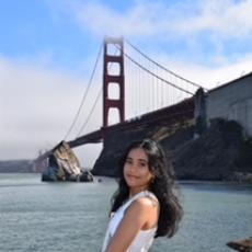 picture of Esha smiling in front of the Golden Gate Bridge!