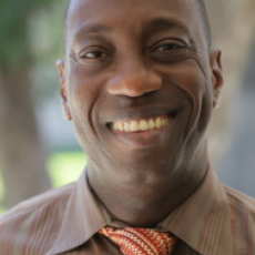 MC President Dr. Julius Sokenu is shown smiling at the camera.