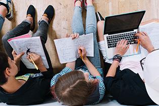 Top view of college students studying together.