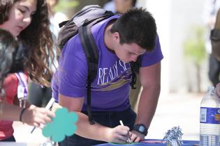 A Student signing up during a campus event.