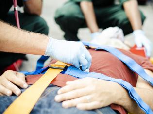 Emergency technicians checking the vitals on a patient.