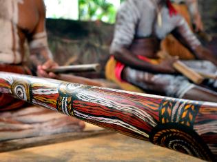 A wooden tool with decorative tribal markings.