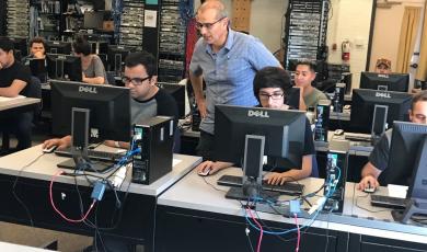 Moorpark College students in a classroom with computers.