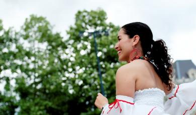 A latina woman dressed in a traditional outfit. 