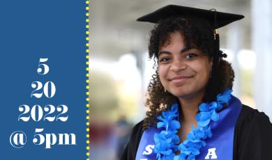 female graduate in cap and gown wearing blue Hawaiian flowers